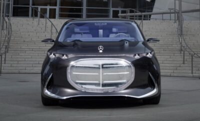 Futuristic black luxury car with a large silver grille and sleek design.