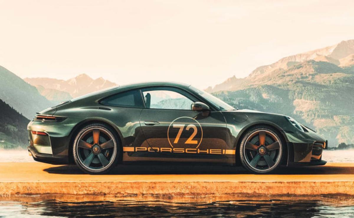 Black Porsche 911 with number 72 decal parked by mountains at sunset.
