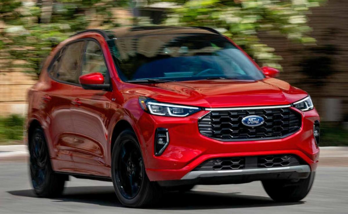 Red compact SUV driving on a road with blurred background.