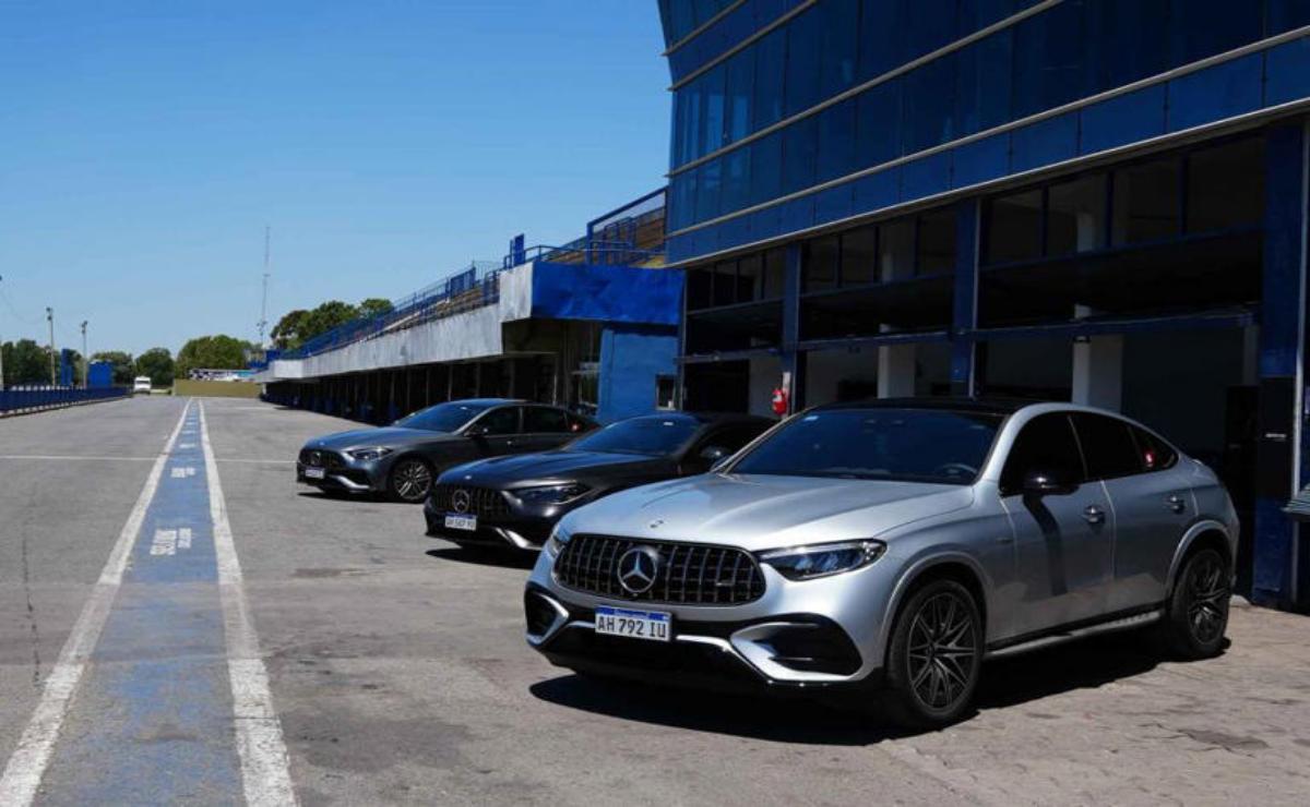 A lineup of luxury Mercedes-Benz cars parked outside a dealership.