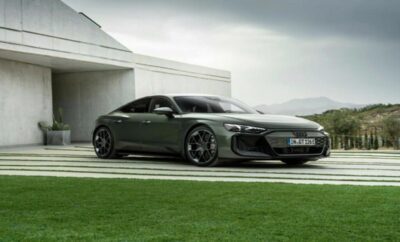 A sleek black luxury sports car parked near a modern white building.