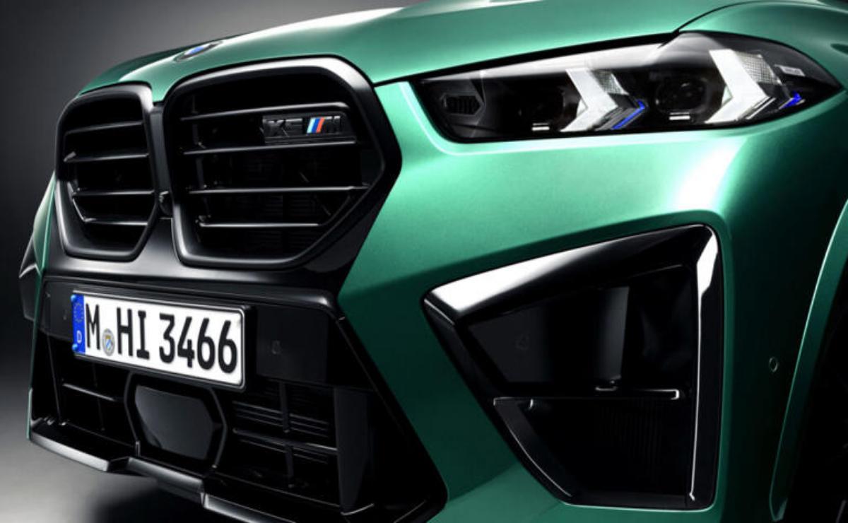 Close-up of a green sports car's front grille and headlight.
