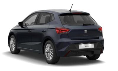 Dark blue SEAT hatchback car parked on white background.