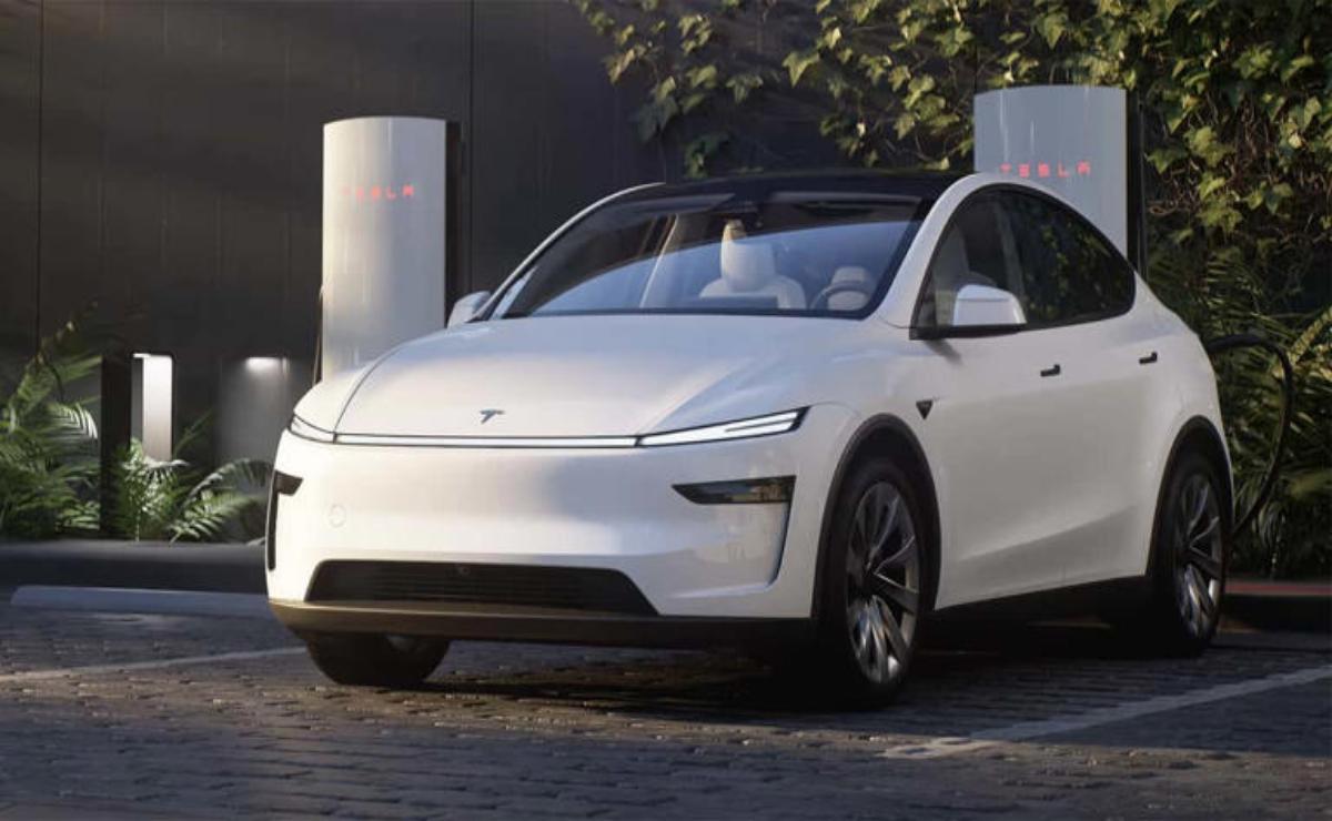 A sleek white electric car parked outdoors during sunset.