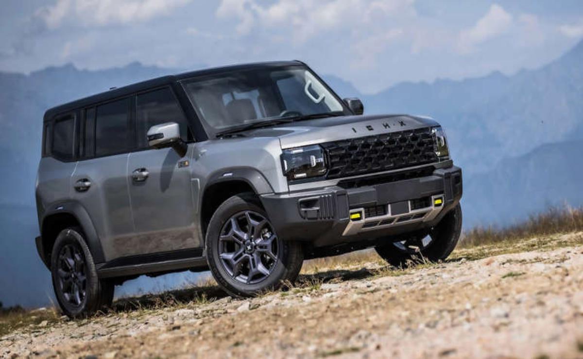 A rugged off-road SUV parked on rocky terrain under a cloudy sky.