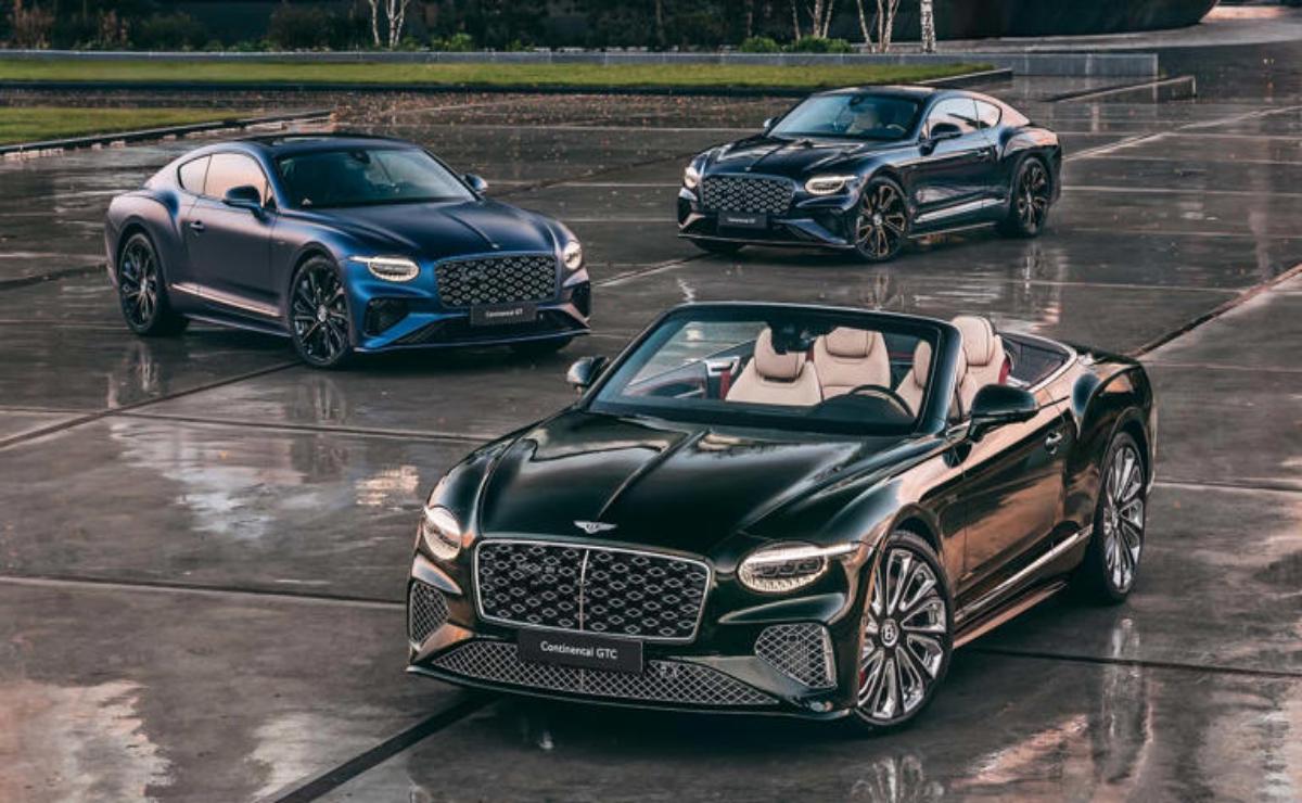 Luxury Genesis cars showcased in a sleek indoor display with dramatic lighting.