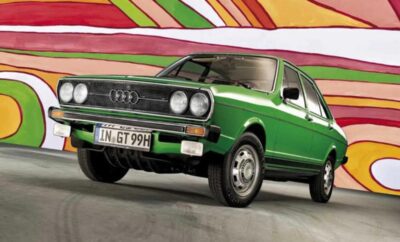 Classic green Volkswagen Golf Mk1 with colorful abstract background.