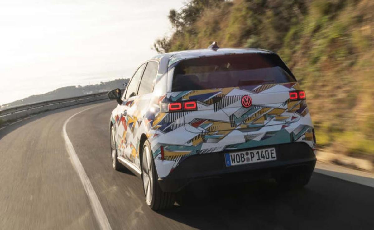 A colorful car with cartoon graphics driving on a road.