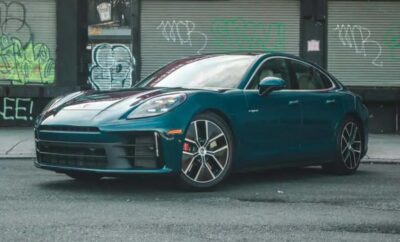 Sleek blue sports car parked in an urban alley with graffiti.