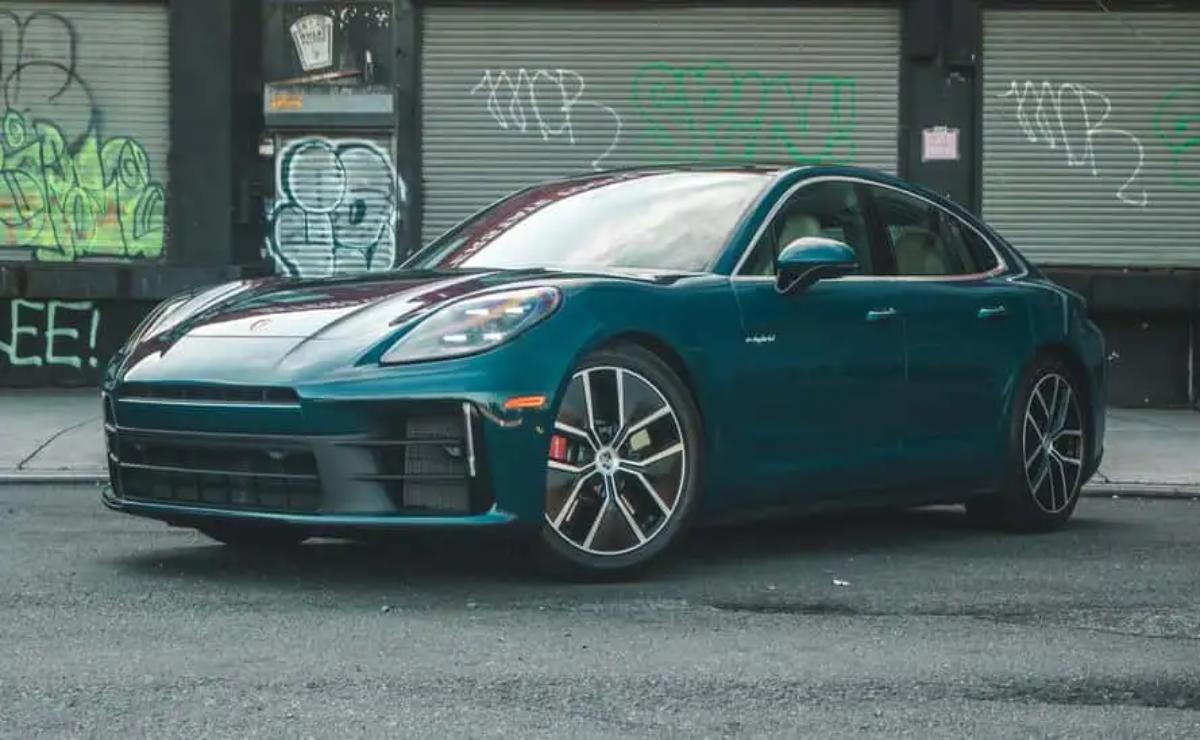 Sleek blue sports car parked in an urban alley with graffiti.