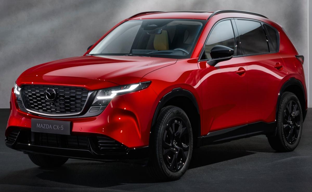 Sleek red SUV with black accents under moody lighting.