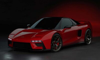 Sleek red sports car with black accents under moody lighting.