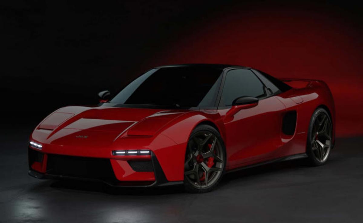 Sleek red sports car with black accents under moody lighting.