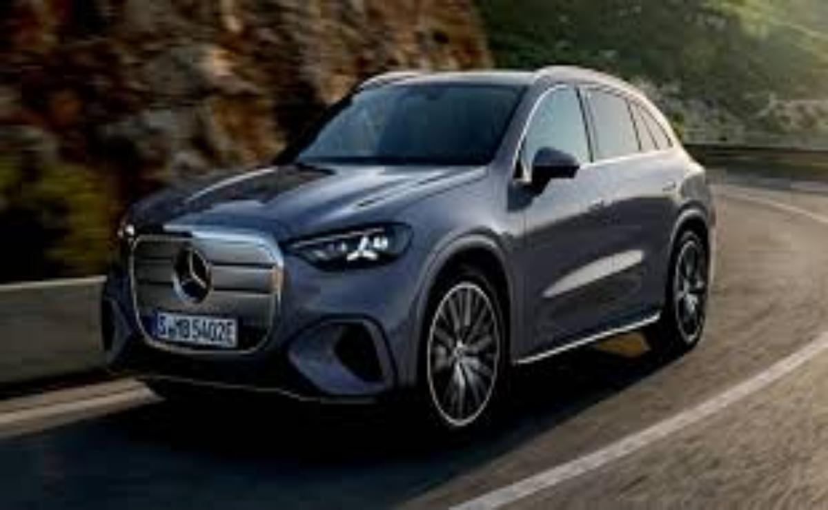 A sleek Mercedes electric SUV driving on a mountain road.