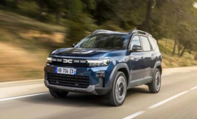 Blue SUV driving on a road with motion blur background.
