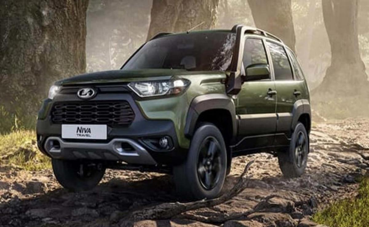 Green rugged SUV parked on rocky terrain under a cloudy sky.