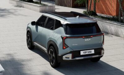 Futuristic compact SUV in metallic blue parked on a street.