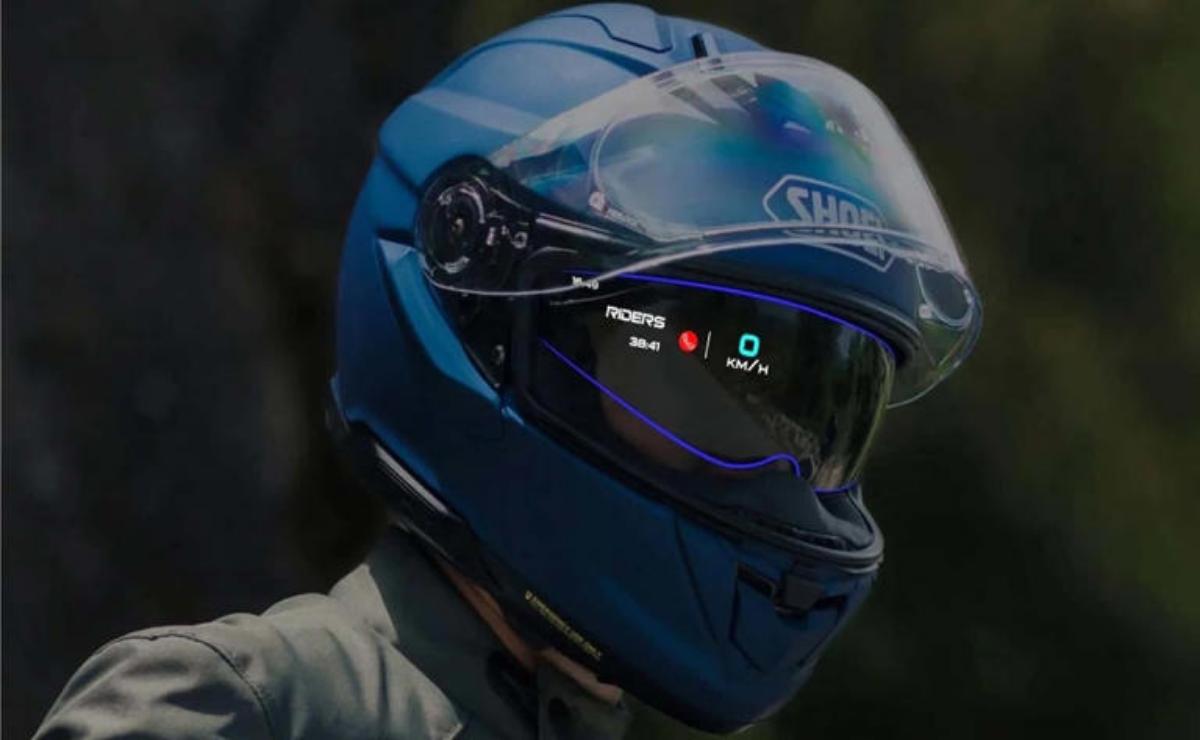 Person wearing a blue motorcycle helmet with a digital HUD display.