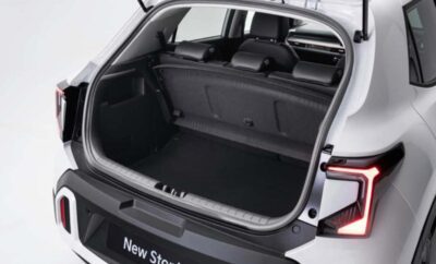 Open trunk of a white car showing spacious cargo area.