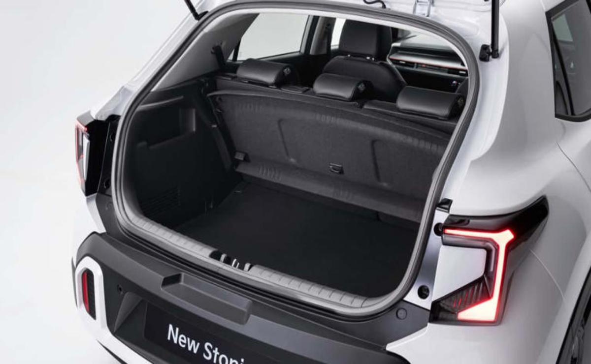 Open trunk of a white car showing spacious cargo area.
