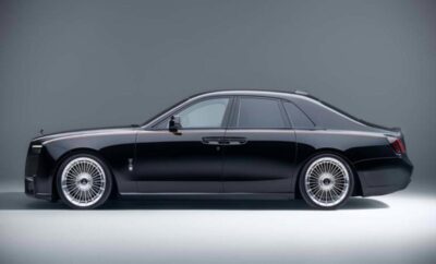 Sleek black luxury sedan with polished alloy wheels against a gray background.