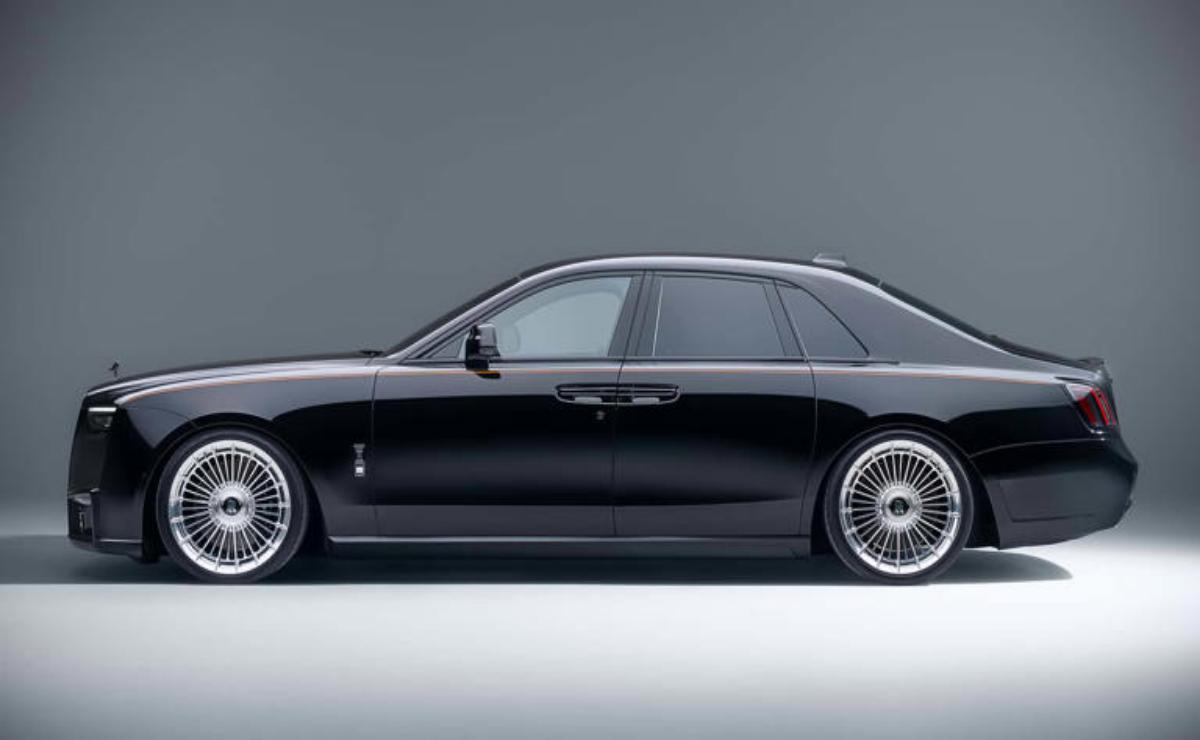 Sleek black luxury sedan with polished alloy wheels against a gray background.
