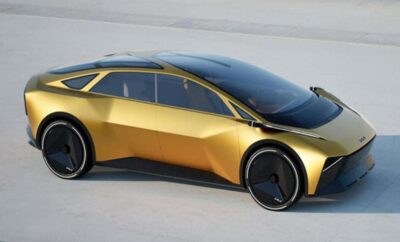 Futuristic gold-colored electric car with sleek design and unique geometric shapes.