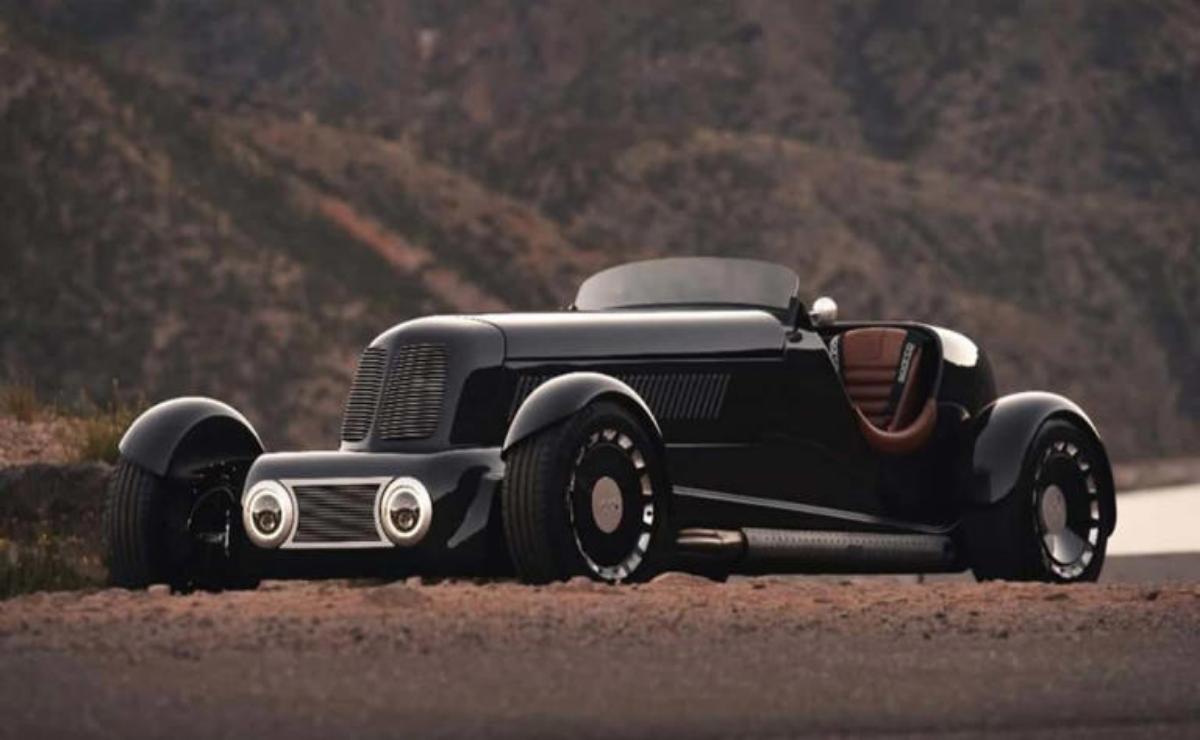 Sleek black vintage hot rod car parked on a desert road.