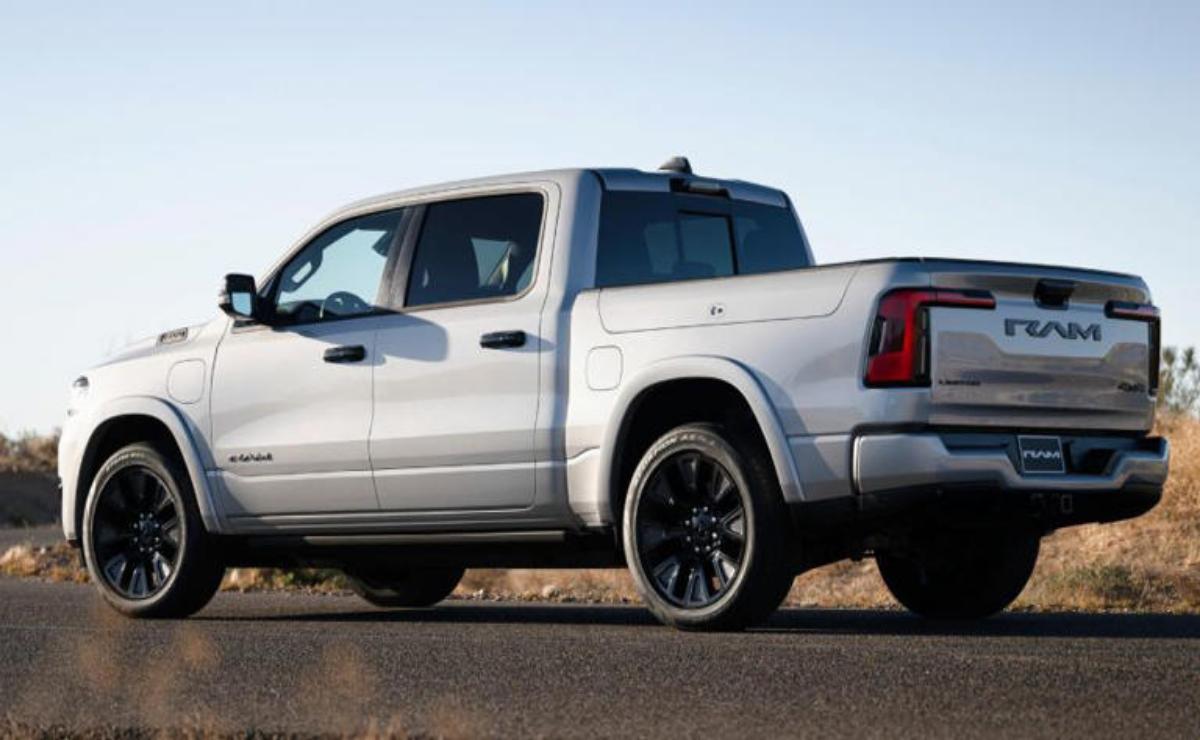 Silver pickup truck parked on a road with a clear sky.