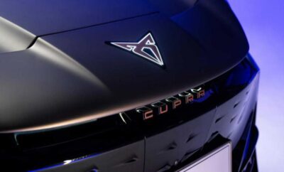 Close-up of a sleek black car hood with a futuristic logo.