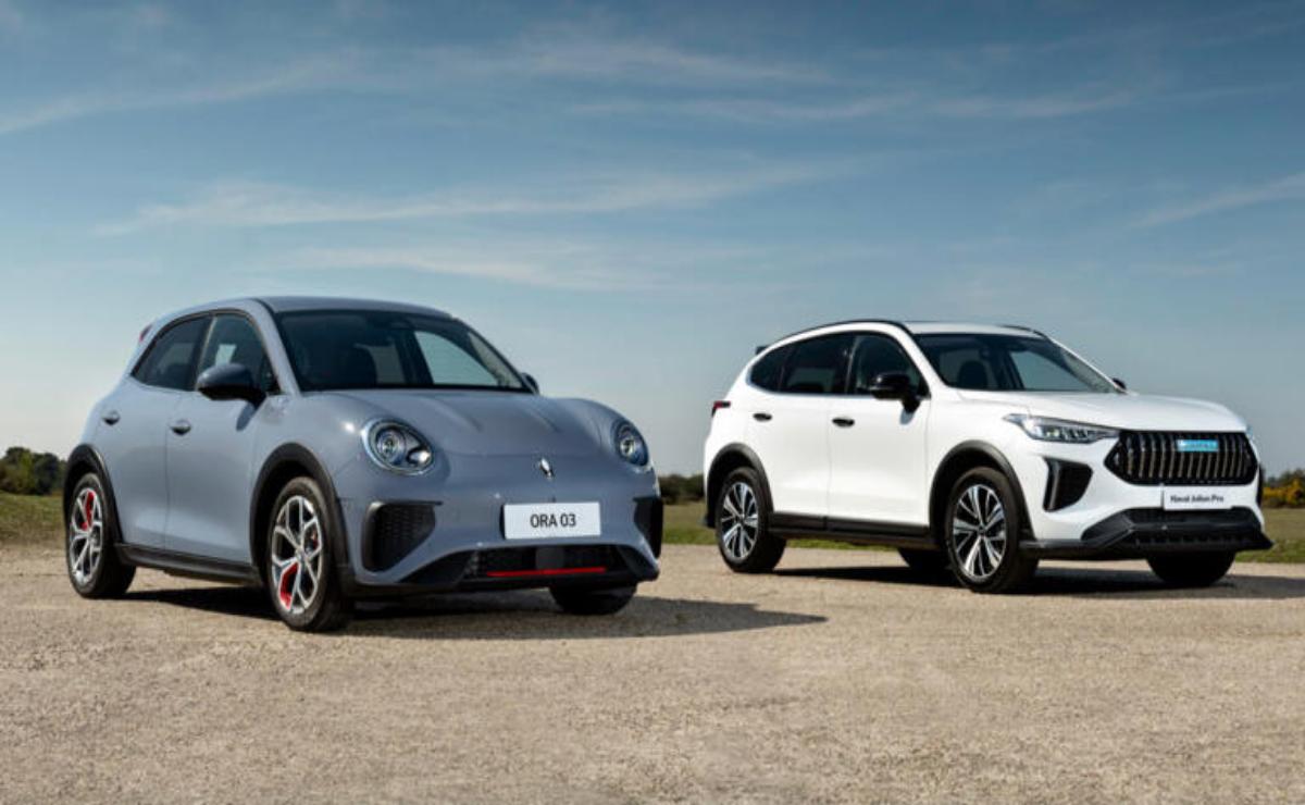 Two modern electric SUVs parked side by side under a clear sky.