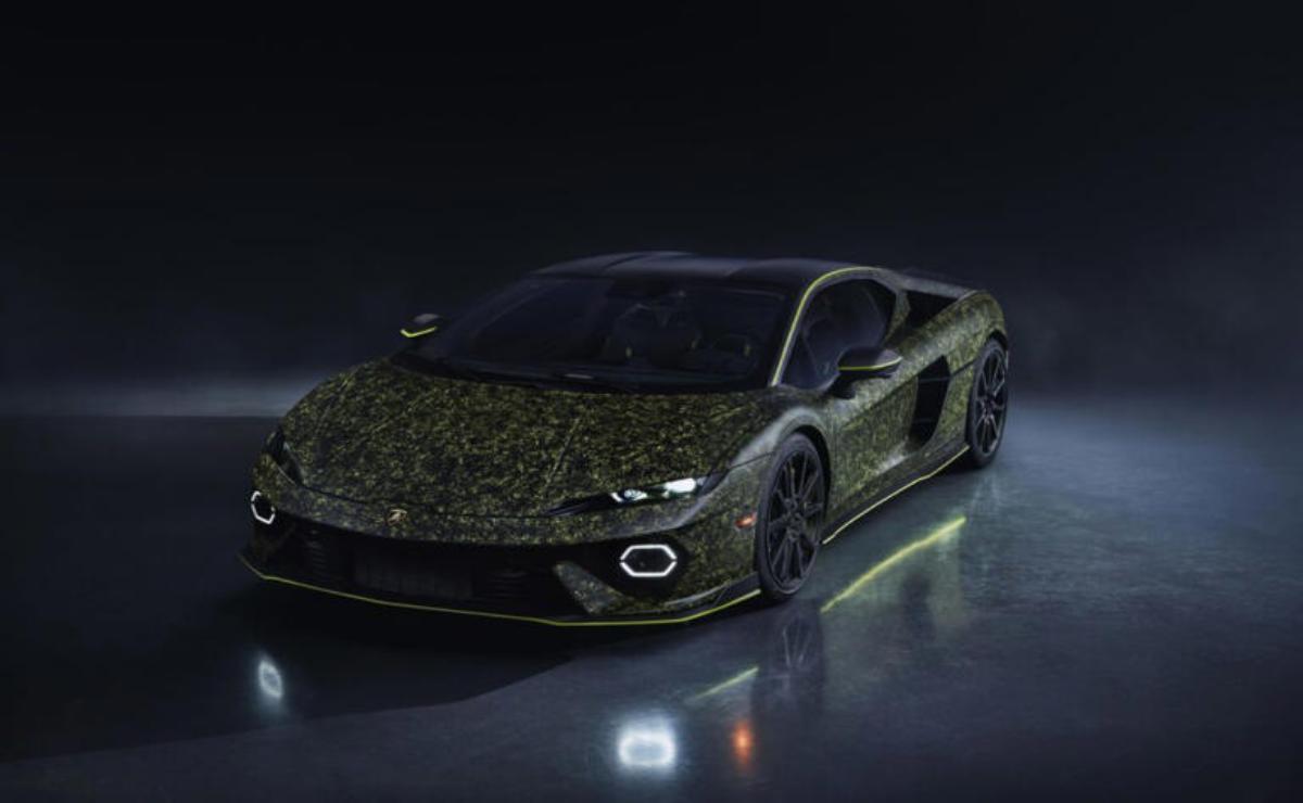 Sleek black sports car with glowing green accents in a dark setting.