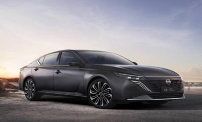 Sleek modern gray sedan with stylish alloy wheels under soft evening light.