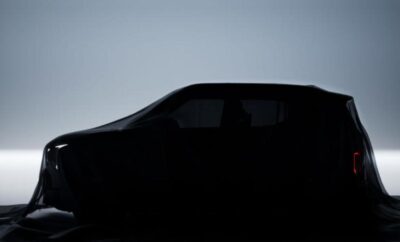Silhouette of a car against a dim sky.