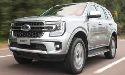 Silver Ford SUV driving on a road.