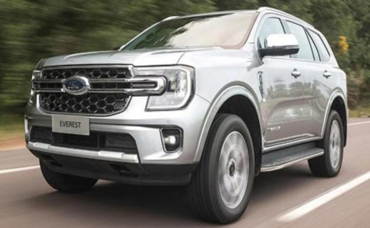 Silver Ford SUV driving on a road.