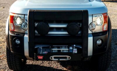 Front view of a rugged vehicle with a heavy-duty winch and protective grille.