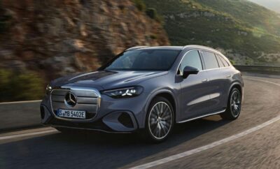 A sleek silver Mercedes-Benz driving on a mountain road.