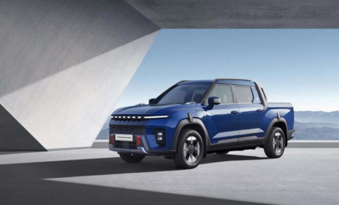A sleek blue electric SUV parked by a modern architectural structure.