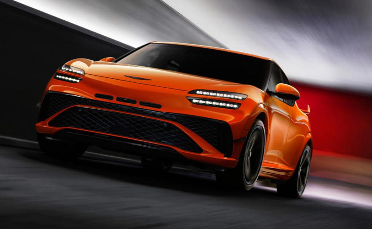Sleek orange sports car speeding through a tunnel.
