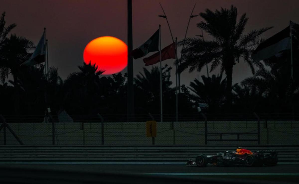 A vibrant sunset with silhouetted palm trees and flags fluttering.