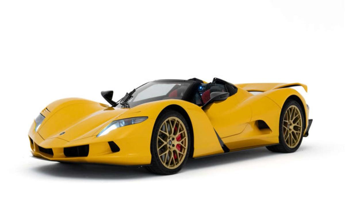 Yellow luxury sports car with red-accented wheels on white background.