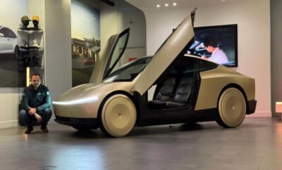 Futuristic car with gull-wing doors and sleek design on display.