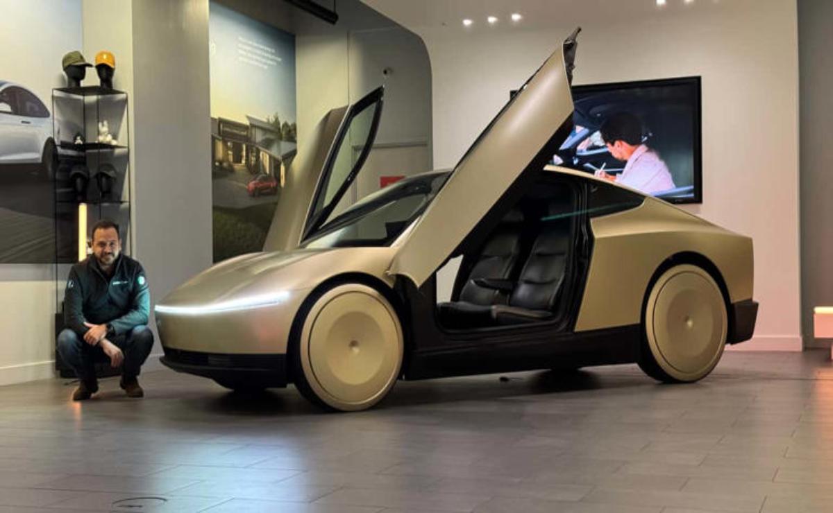 Futuristic car with gull-wing doors and sleek design on display.