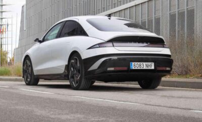 Sleek white electric car parked in an urban setting.