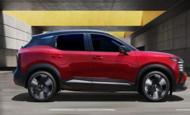 Red SUV parked indoors with tinted windows and black wheels.