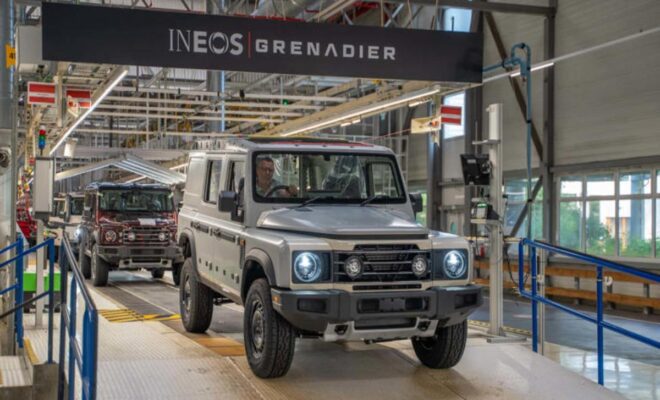 A rugged INEOS Grenadier vehicle inside a modern assembly plant.