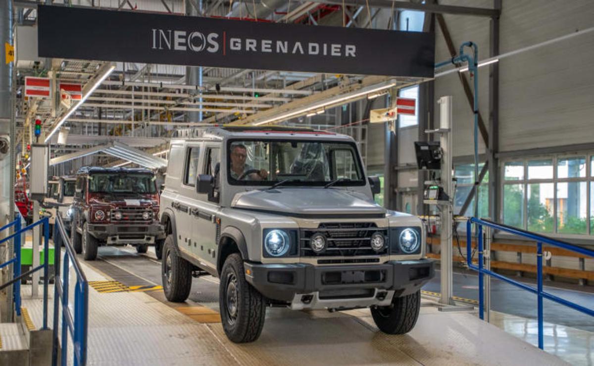 A rugged INEOS Grenadier vehicle inside a modern assembly plant.