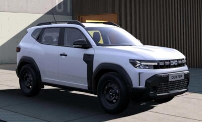 A white SUV with black accents parked outside a modern building.