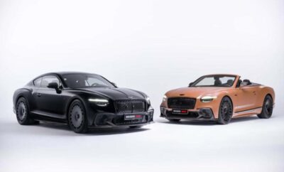 Two luxury sports cars, one black and one orange, parked side by side.
